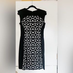 Black and white Maggy London sheath dress with zippered detailing on shoulders
